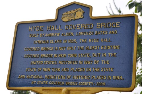 Sign for Hyde Hall Covered Bridge, built in 1825, highlighting its historical significance in New York and the U.S.