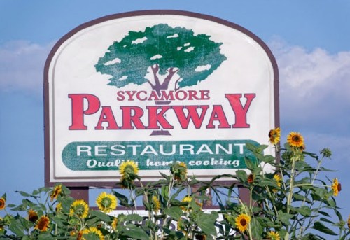 Sign for Sycamore Parkway Restaurant, featuring sunflowers and the tagline "Quality home cooking."