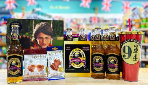 A display of Harry Potter-themed snacks and drinks, including bottles, sweets, and a themed cup.