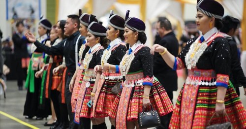 A group of dancers in colorful traditional attire performing at a cultural event.