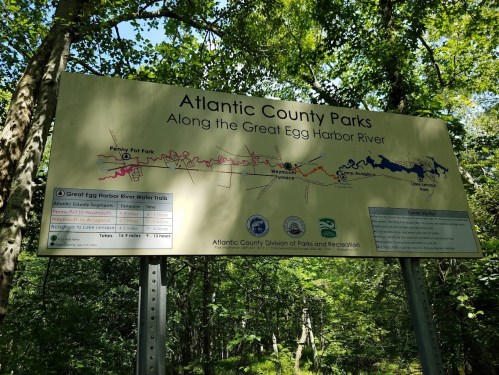 Sign for Atlantic County Parks along the Great Egg Harbor River, detailing trails and park information.