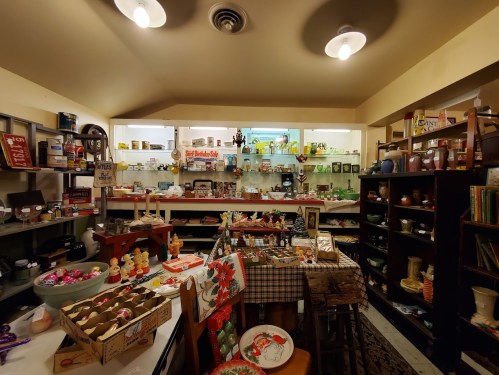 A cozy vintage shop filled with various antiques, collectibles, and colorful decor on display.