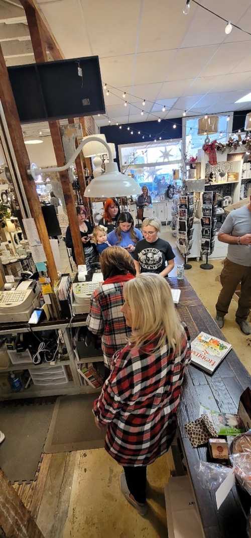 A busy store interior with customers in line at the counter, surrounded by various merchandise and decorations.