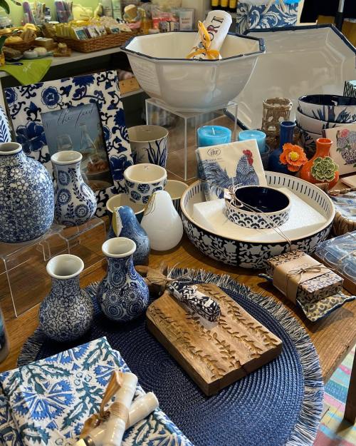 A display of decorative kitchenware and home goods in blue and white patterns, including vases, bowls, and table linens.