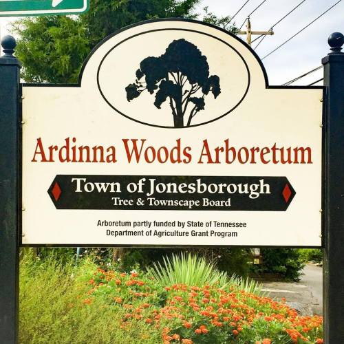 Sign for Ardinna Woods Arboretum in Jonesborough, featuring trees and landscaping, funded by the State of Tennessee.
