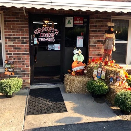 Entrance to Granny's Diner, featuring a welcoming display of pumpkins, hay, and a scarecrow.