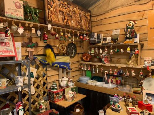 A cozy display of various decorative items, including ornaments, figurines, and holiday decorations in a wooden setting.
