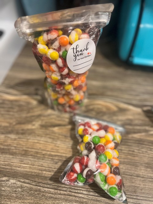 Two clear bags filled with colorful candies, one upright and one on its side, with a "Thank You" label.