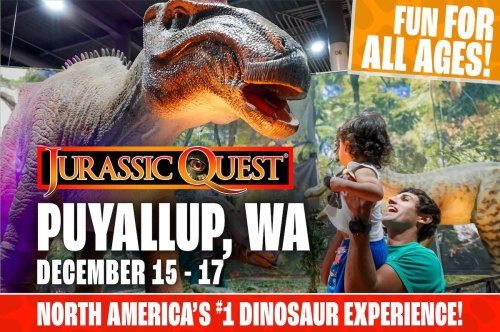 A child and adult interact with a life-sized dinosaur display at Jurassic Quest in Puyallup, WA, December 15-17.