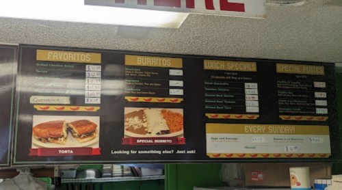 Menu board featuring favorites, burritos, lunch specials, and special plates with prices listed.