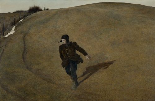 A solitary figure in a dark coat runs across a barren, grassy landscape under a muted sky.