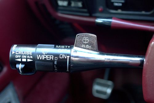 Close-up of a car's windshield wiper control lever with settings for mist, off, and on.