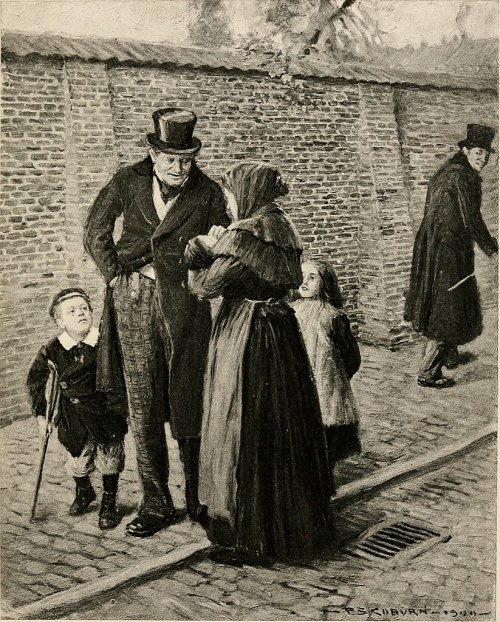 A man in a top hat converses with a woman holding a child, while two children stand nearby on a cobblestone street.