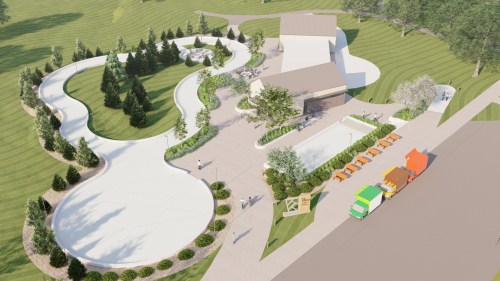 Aerial view of a landscaped park featuring pathways, trees, a building, and colorful vehicles parked nearby.