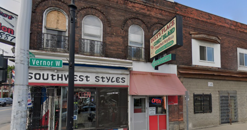 A street view of a brick building with a restaurant sign and a shop called "Southwest Styles" nearby.