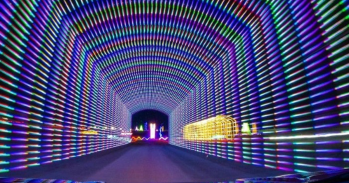 A vibrant, colorful light tunnel with streaks of neon lights creating a mesmerizing pattern.