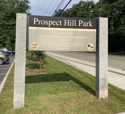 Sign for Prospect Hill Park, Waltham, MA, established in 1803, with information about the Parks and Recreation Department.