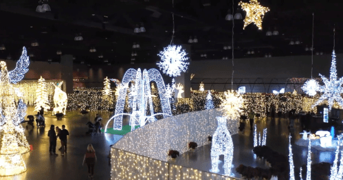 A festive indoor display featuring numerous sparkling lights, snowflakes, and holiday decorations.