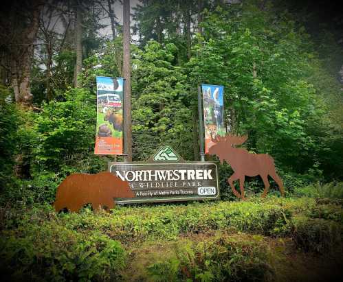 Sign for Northwest Trek Wildlife Park surrounded by greenery, featuring silhouettes of a bear and a moose.