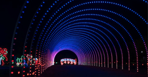 A colorful light tunnel with blue and purple lights, featuring a "Peace on Earth" sign at the end.