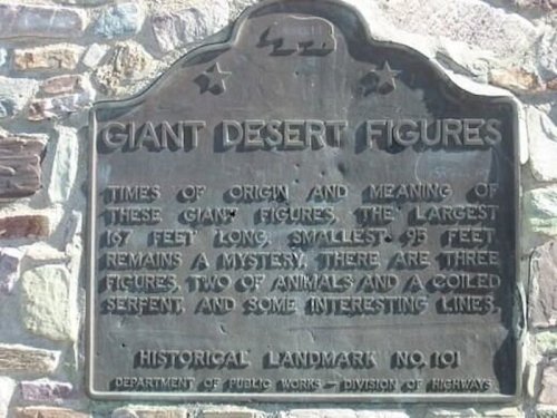 A plaque describing the Giant Desert Figures, noting their sizes and historical significance as a landmark.
