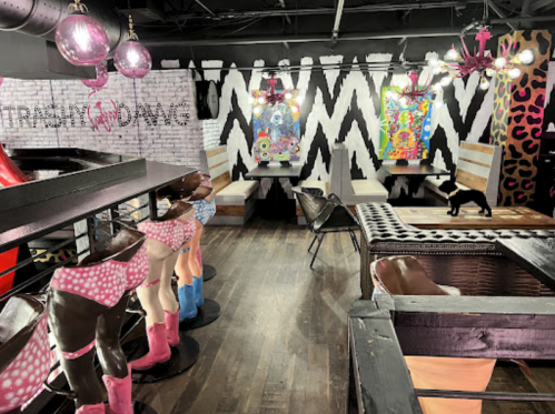 A vibrant interior featuring colorful art, unique decor, and playful mannequins in a lively setting.