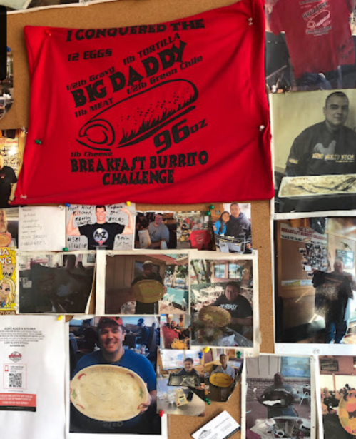 A bulletin board displaying photos and a red banner celebrating a breakfast burrito challenge victory.