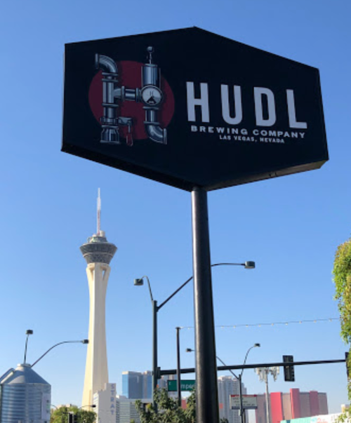 Sign for Hudl Brewing Company with the Stratosphere Tower in the background, Las Vegas, Nevada.