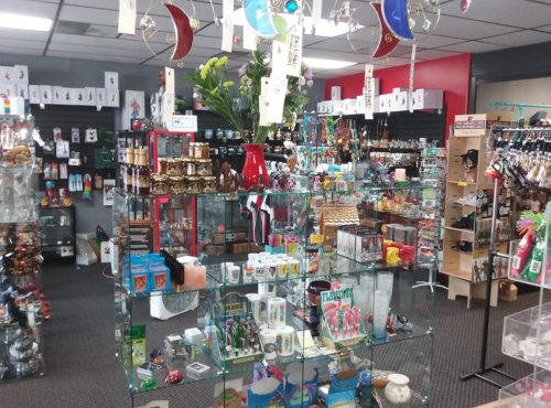 A colorful gift shop filled with various items, including souvenirs, decorations, and trinkets displayed on shelves and tables.
