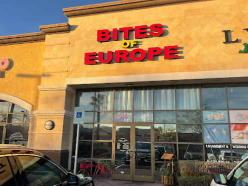 Exterior of "Bites of Europe" restaurant with large red signage and glass doors, featuring a welcoming entrance.