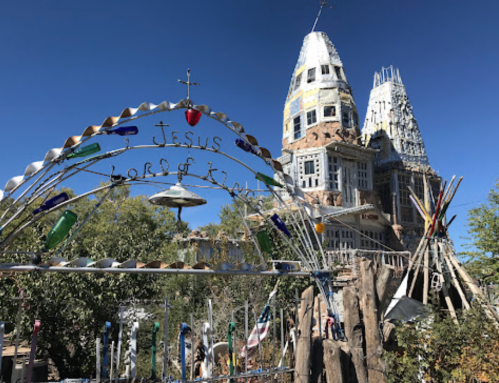 A whimsical structure with towers, adorned with colorful decorations and a sign reading "Jesus, Lord of Zion."