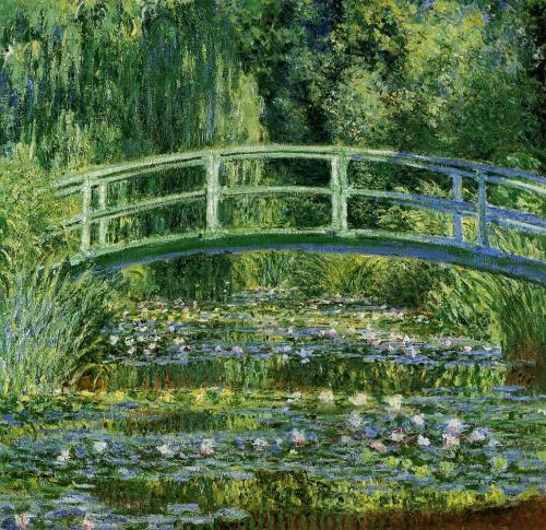 A serene garden scene featuring a green bridge over a pond filled with water lilies and lush greenery.