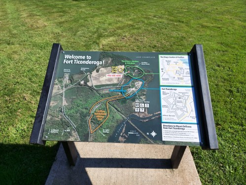 Map sign at Fort Ticonderoga, showing trails, attractions, and directions with "You Are Here" marked.