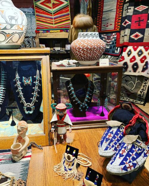 Display of Native American crafts, including jewelry, pottery, and textiles, showcasing vibrant colors and intricate designs.