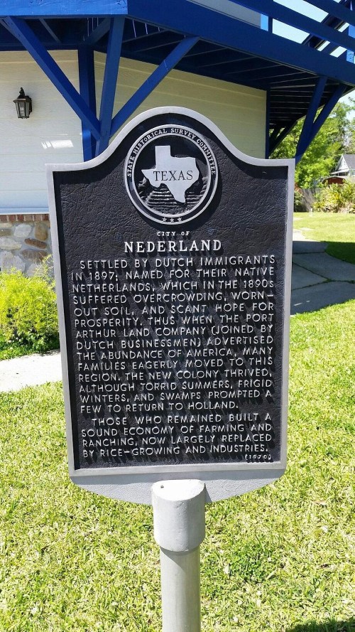 Historical marker for Nederland, Texas, detailing its founding by Dutch immigrants in 1897 and early economic activities.