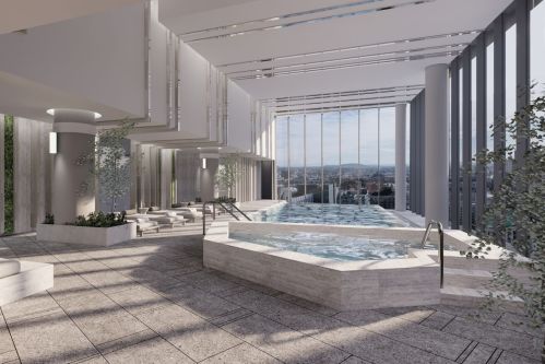 Modern indoor pool area with large windows, sleek design, and city views, featuring lounge chairs and greenery.