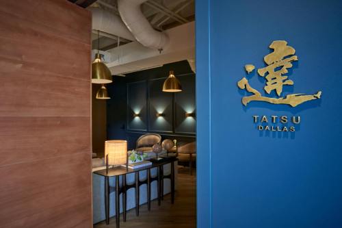 Entrance to Tatsu Dallas, featuring a modern interior with warm lighting and stylish decor.