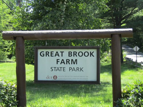 Sign for Great Brook Farm State Park, surrounded by greenery, indicating the park's location in Massachusetts.