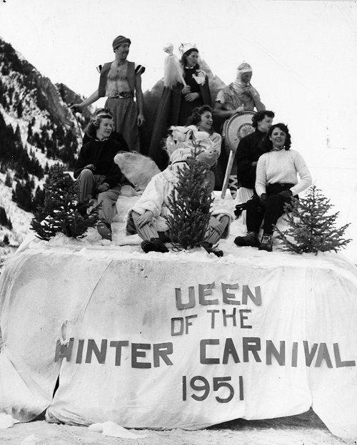 A group of people in costumes poses on a snow structure labeled "Queen of the Winter Carnival 1951."