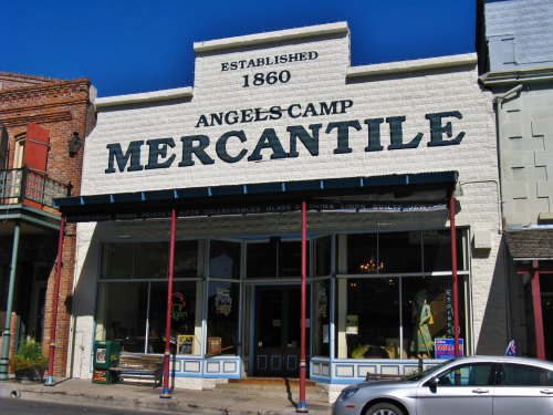 Historic storefront of Angels Camp Mercantile, established in 1860, featuring large signage and a welcoming entrance.