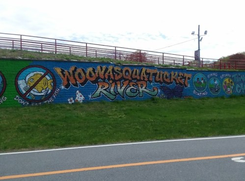 Colorful mural featuring "Woonasquatucket River" with illustrations of fish and recreational activities like biking and boating.