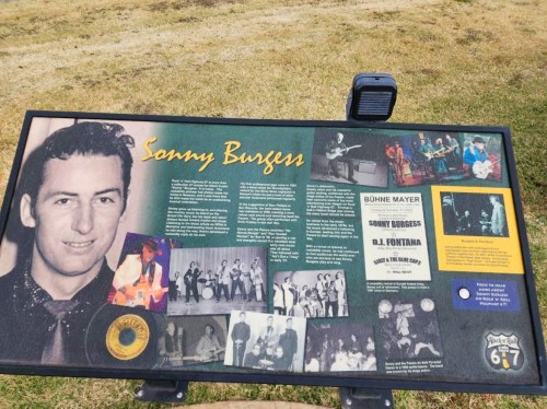 Sign about Sonny Burgess featuring a photo, text, and images of his musical career and performances.