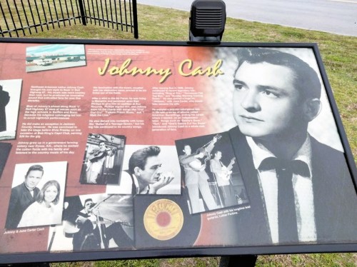 Sign featuring information about Johnny Cash, with images and text detailing his life and musical career.