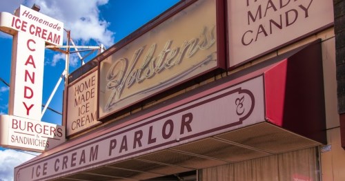 Signage for a vintage ice cream parlor featuring homemade ice cream, candy, burgers, and sandwiches.