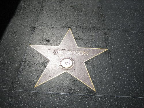 Star on the Hollywood Walk of Fame honoring Kenny Rogers, featuring his name and a circular emblem.