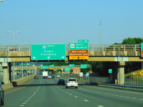 Highway scene with signs for I-95 North, Groton, Providence, and exit for Norwich, New London Waterfront District.