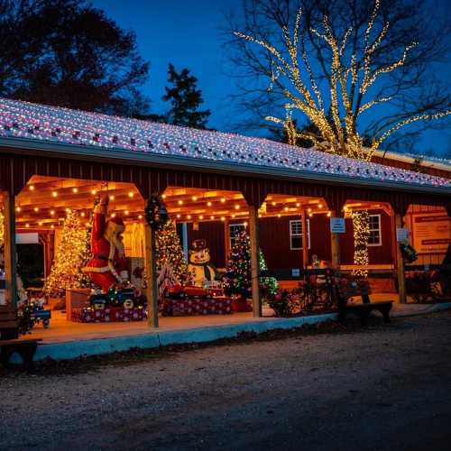 A festive scene featuring a decorated building with colorful lights, holiday decorations, and a snowy roof.