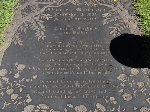 A gravestone for Charles Bronson, featuring an inscription of a poem about life and remembrance.