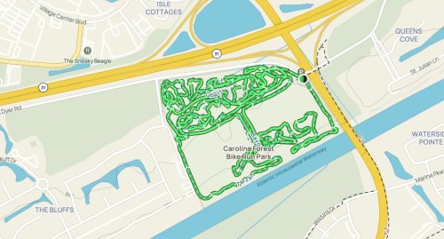 Map showing the layout of Caroline Forest Bike Run Park with winding trails and nearby roads and waterways.
