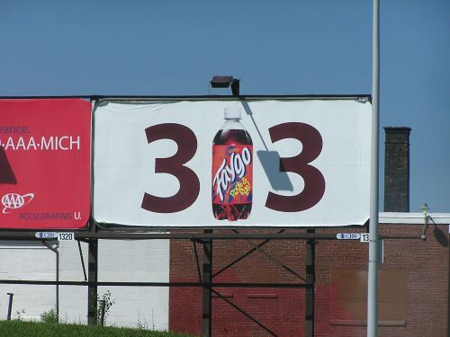 Billboard featuring a Faygo soda bottle with the number "33" prominently displayed.